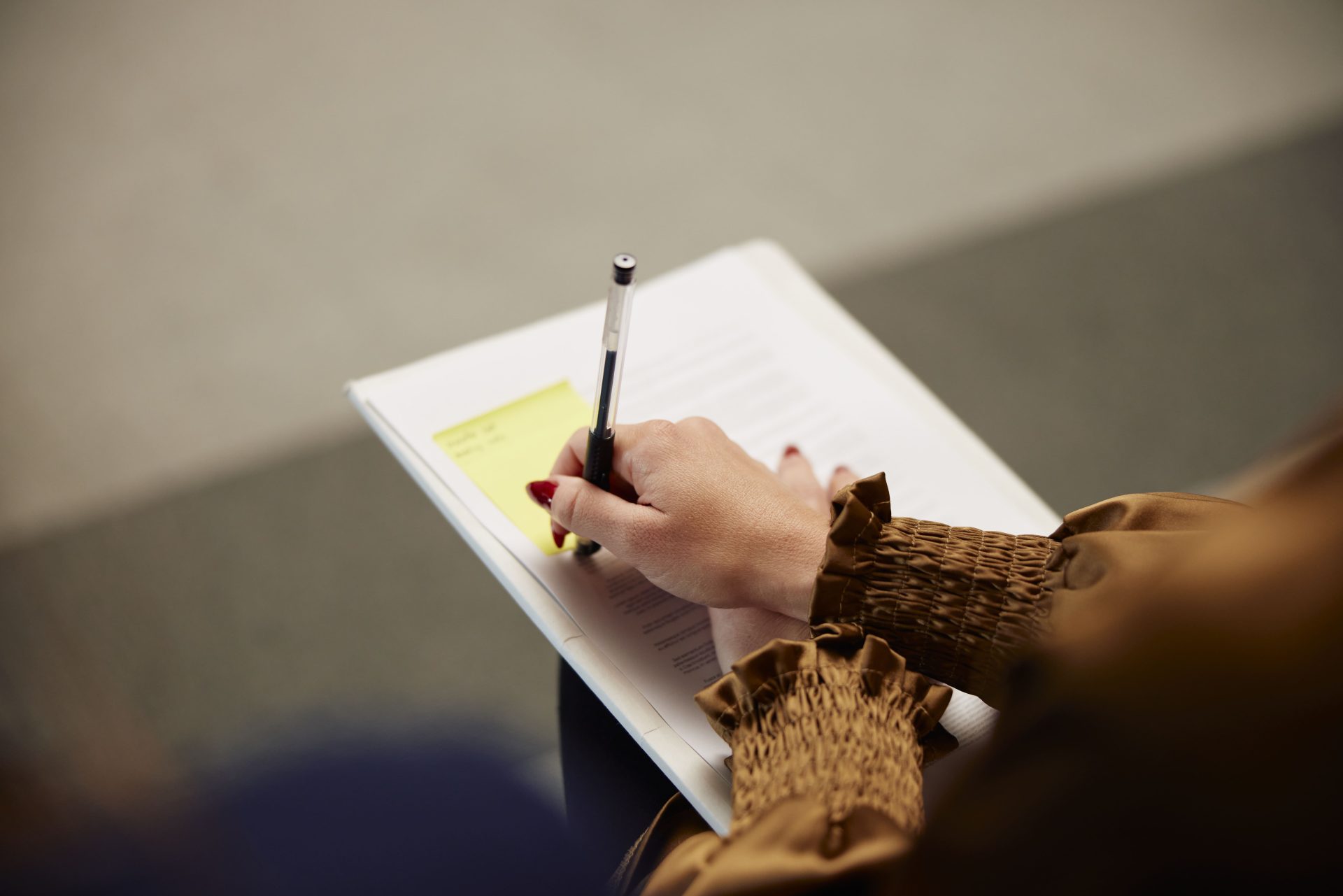 Pen signing a piece of paper