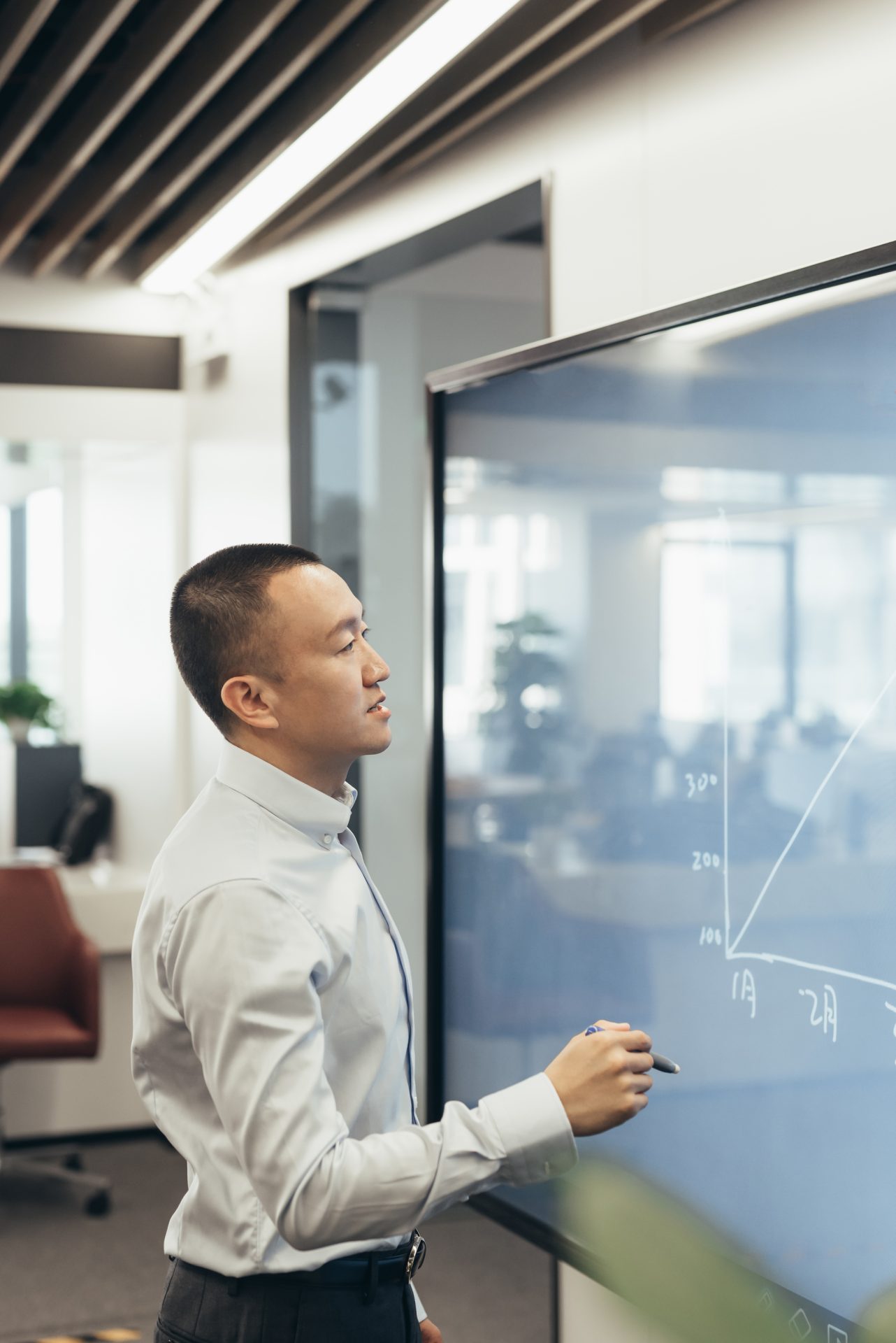 Man writing on a whiteboard.
