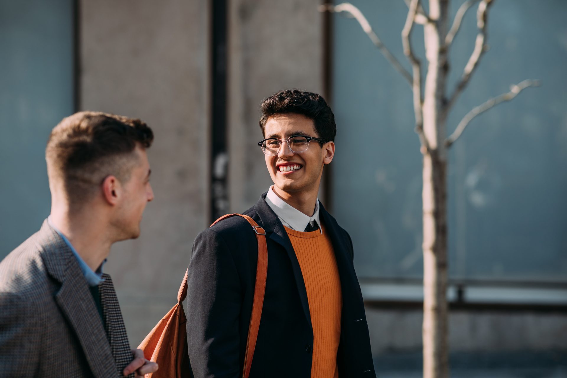 Young men smiling outside.