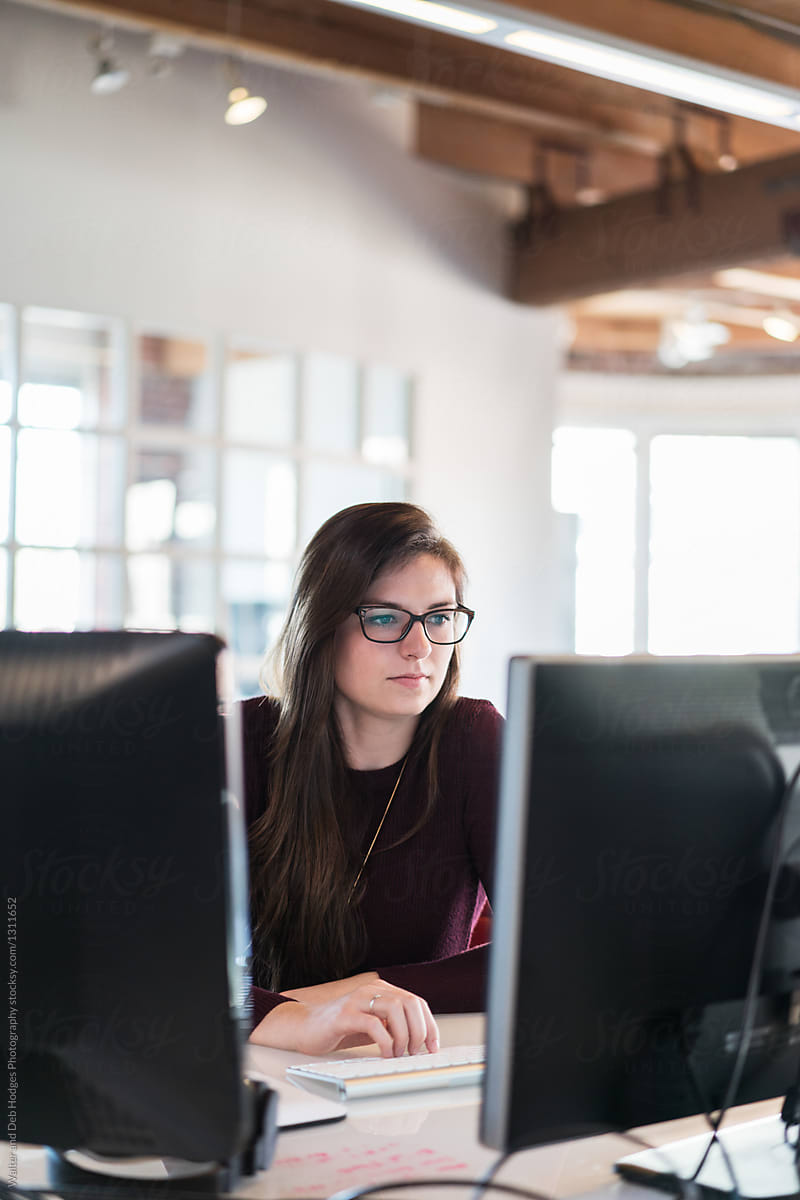 Woman sitting at a computer.